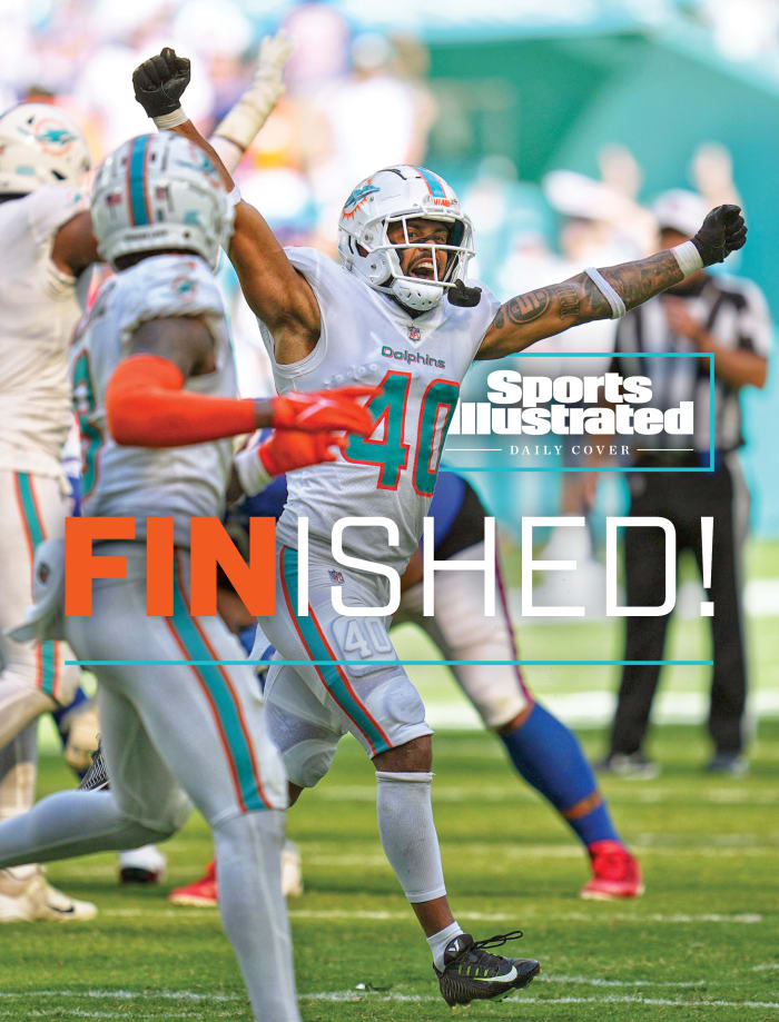 Dolphins players run off the field celebrating after defeating the Bills